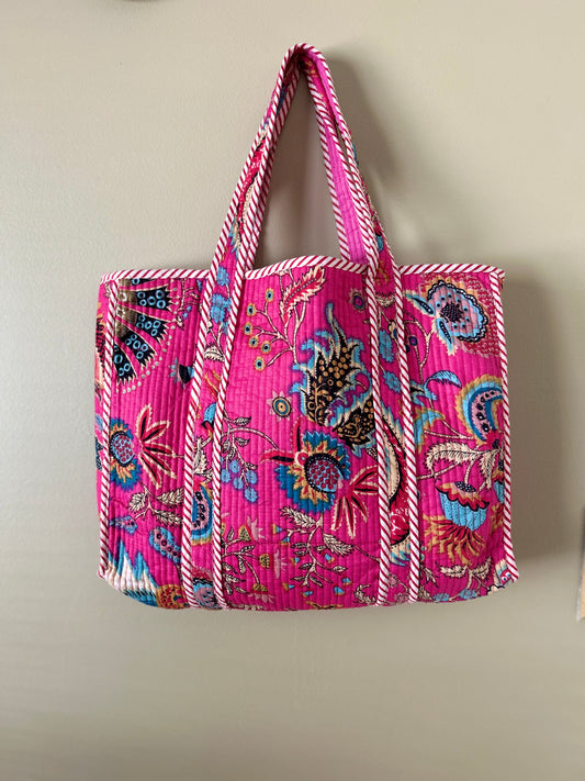 Collection of hand block printed quilted tote bags, showcasing traditional craftsmanship and contemporary designs. Available in five prints and colors: Indigo Neel, Peach Plumari, Pink Blossom, Grey Flora, and Teal Boota. Practical, spacious, and made from breathable fabrics. Support sustainable practices and empower artisans. Elevate your style with these artistic tote bags. Shop now and embrace the beauty of hand block printing.